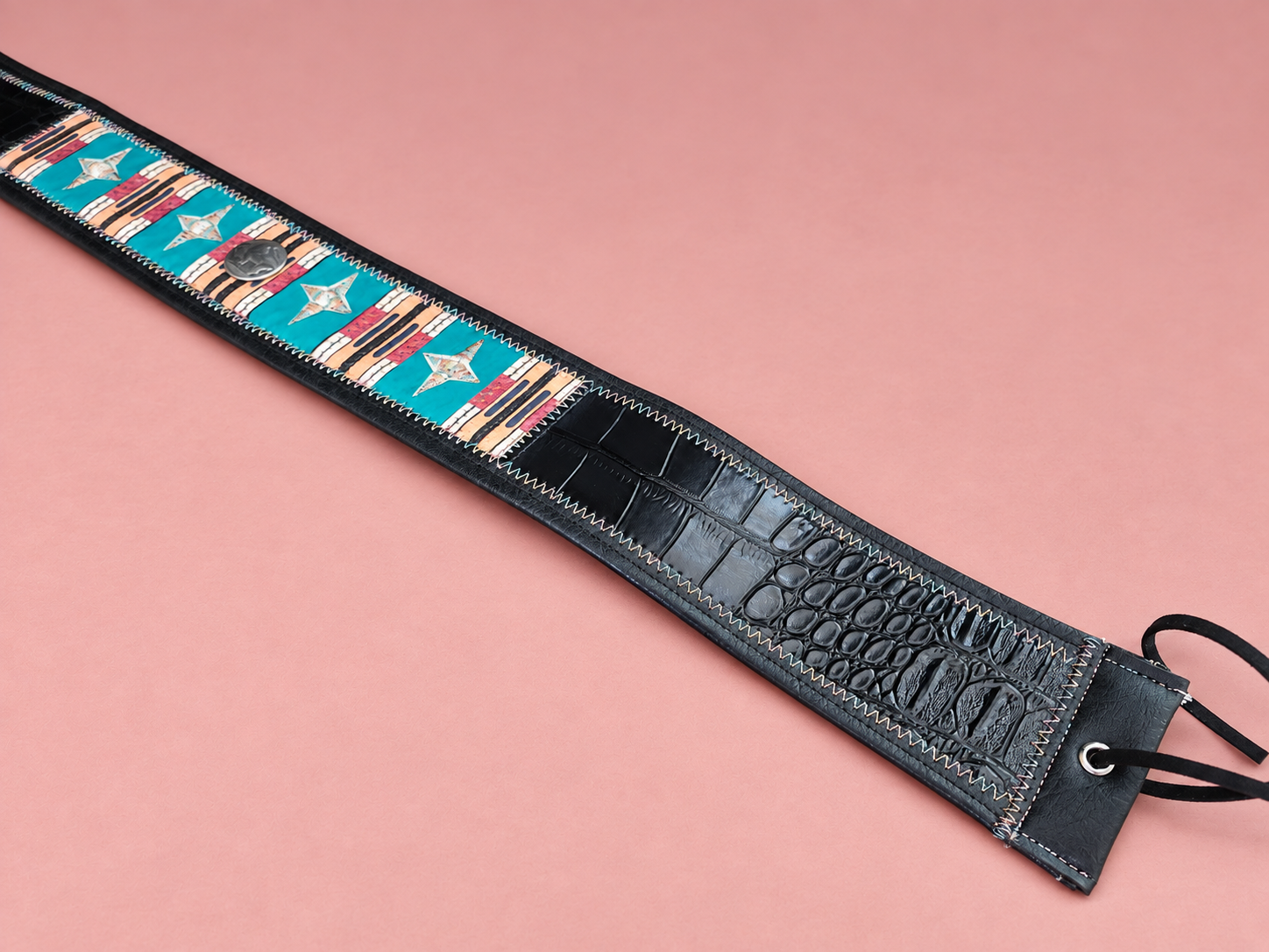 Turquoise western guitar strap on blush pink (1).png