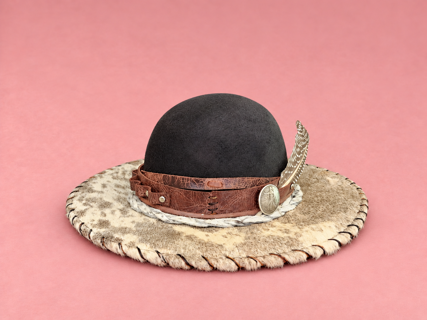 Black western hat on blush pink.png