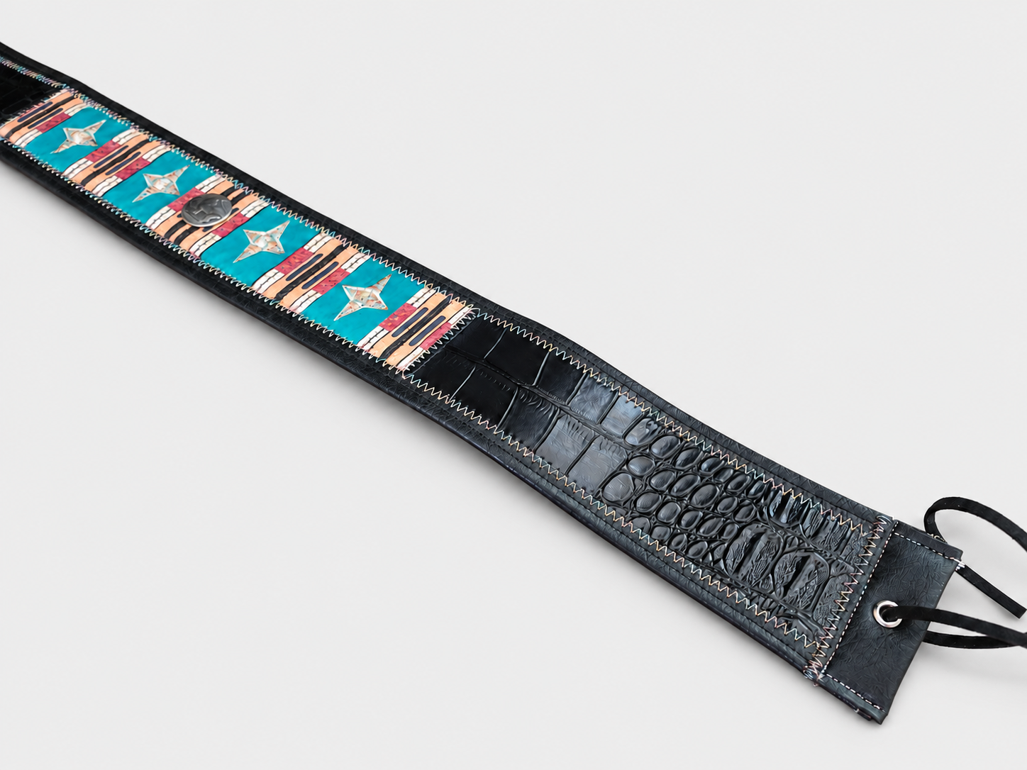 Western guitar strap on light gray.png