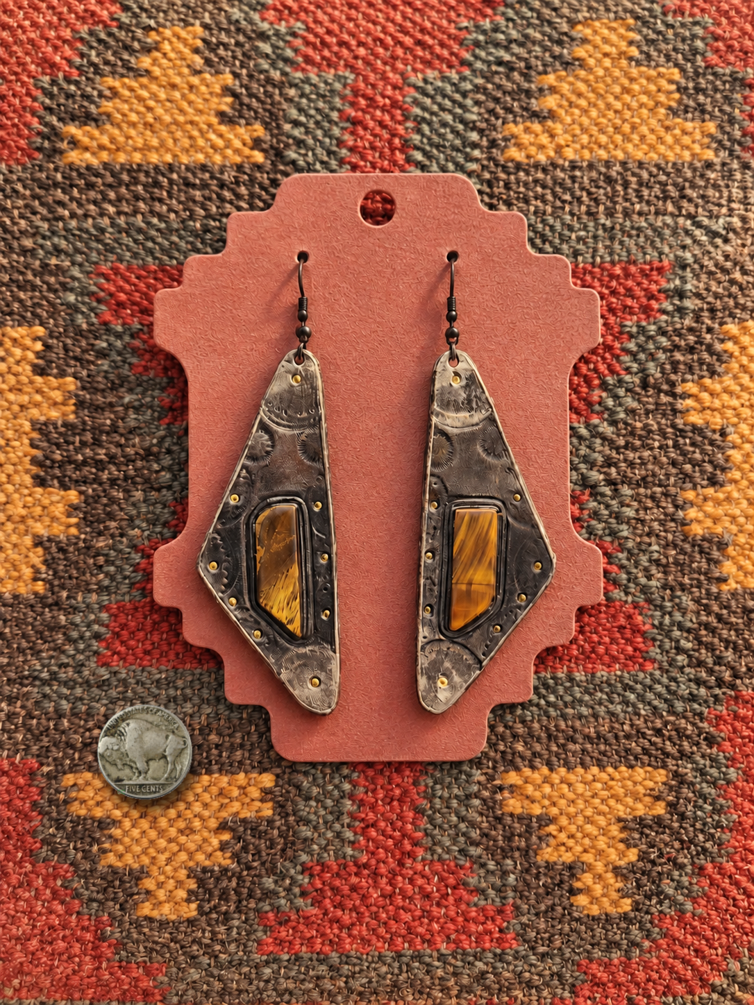 Western earrings on a dusty-rose card (1).png