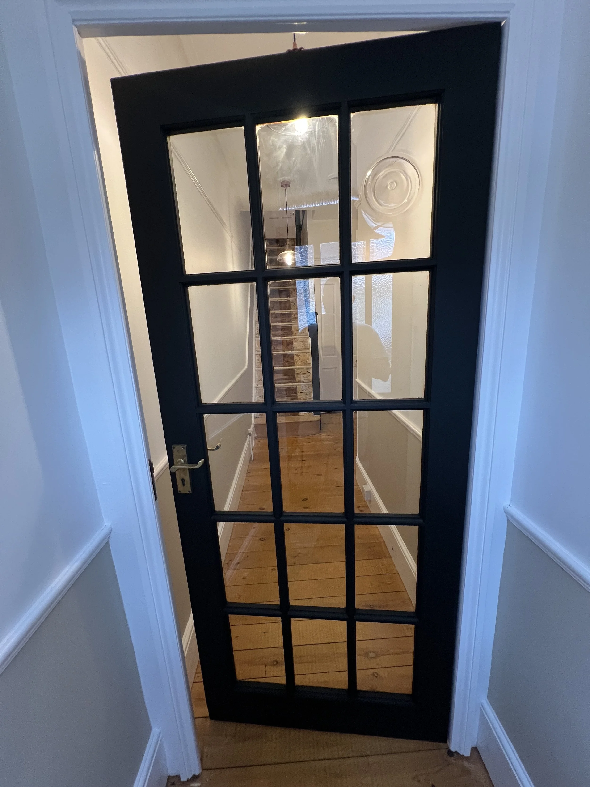 Satin black feature door with precision gloss detailing and clean contrast.