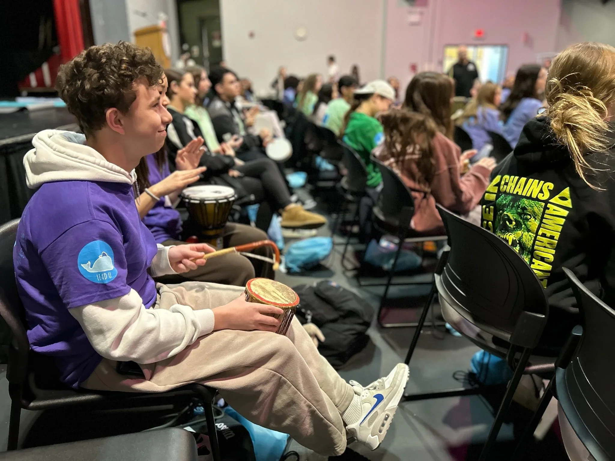 molly college long island ny suicide prevention drum circle 2025 facilitated by laura cerrano of feng shui manhattan and healing drum circles. Group of youth drummers.