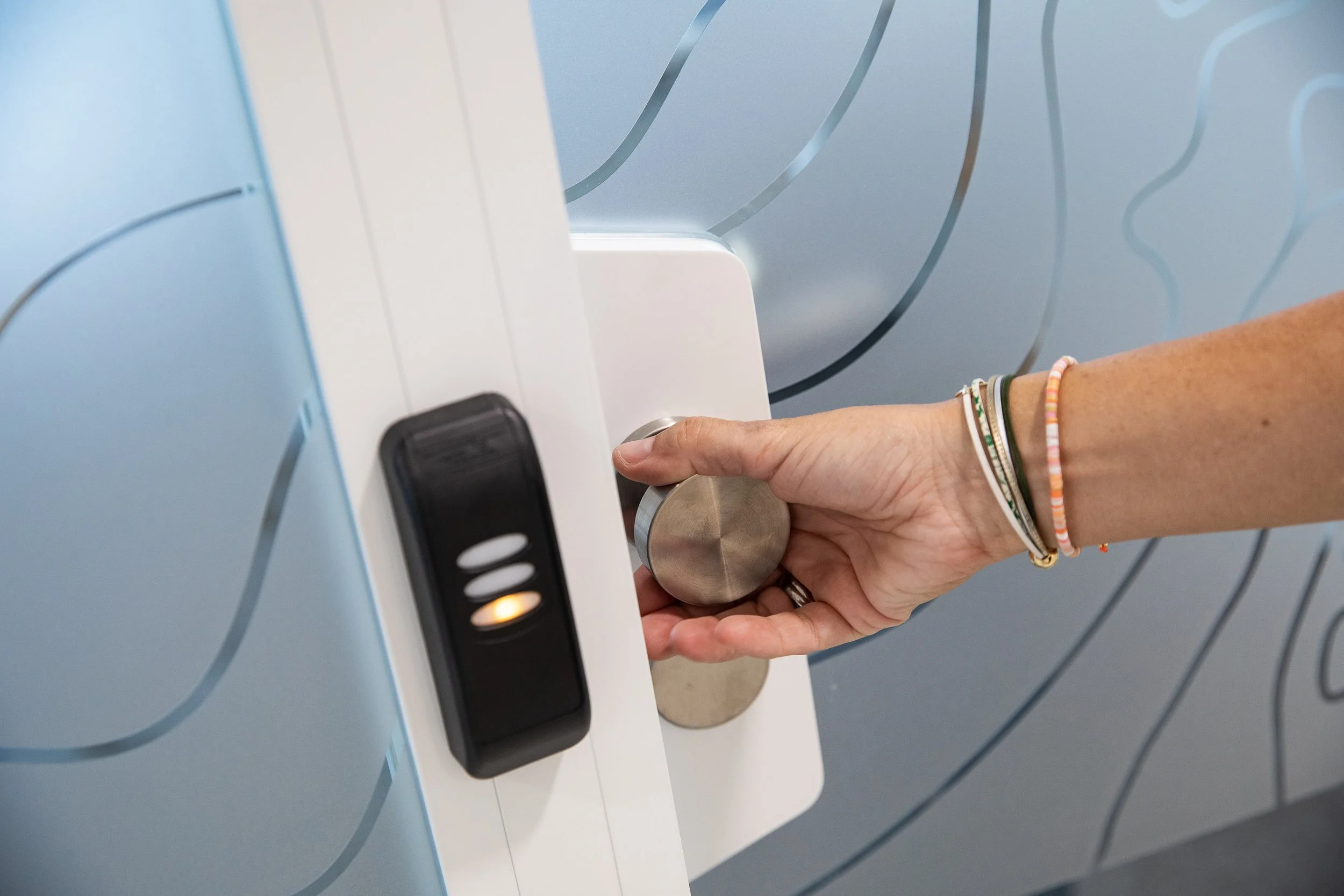 A person pushing a button on an elevator control panel.