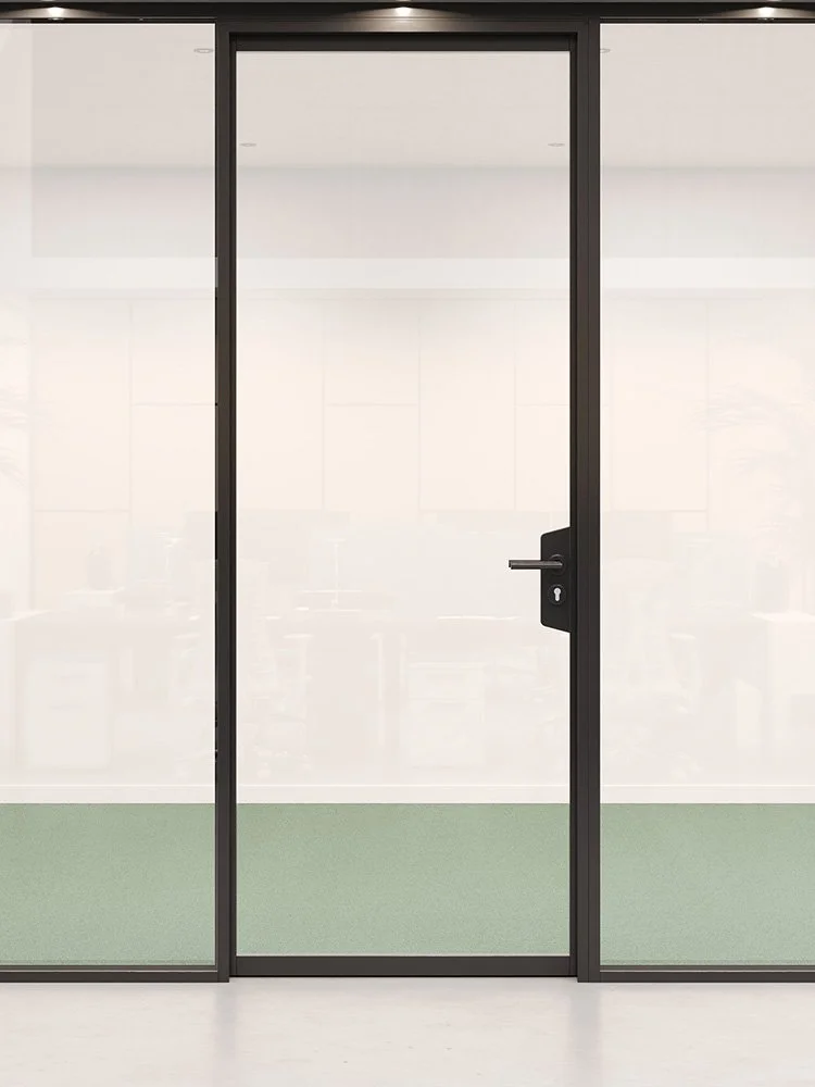 Glass door with black frame and handle, leading to an interior space with green carpeted floor.
