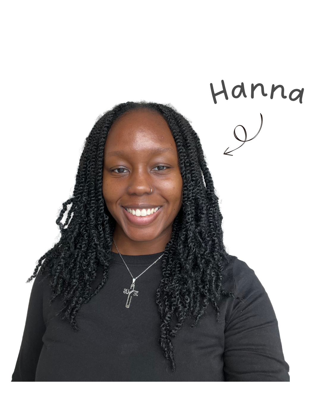 A smiling woman with medium dark skin, with long black twisted hair, wearing a black top, a silver necklace with a cross pendant, and a small nose ring, against a black background.