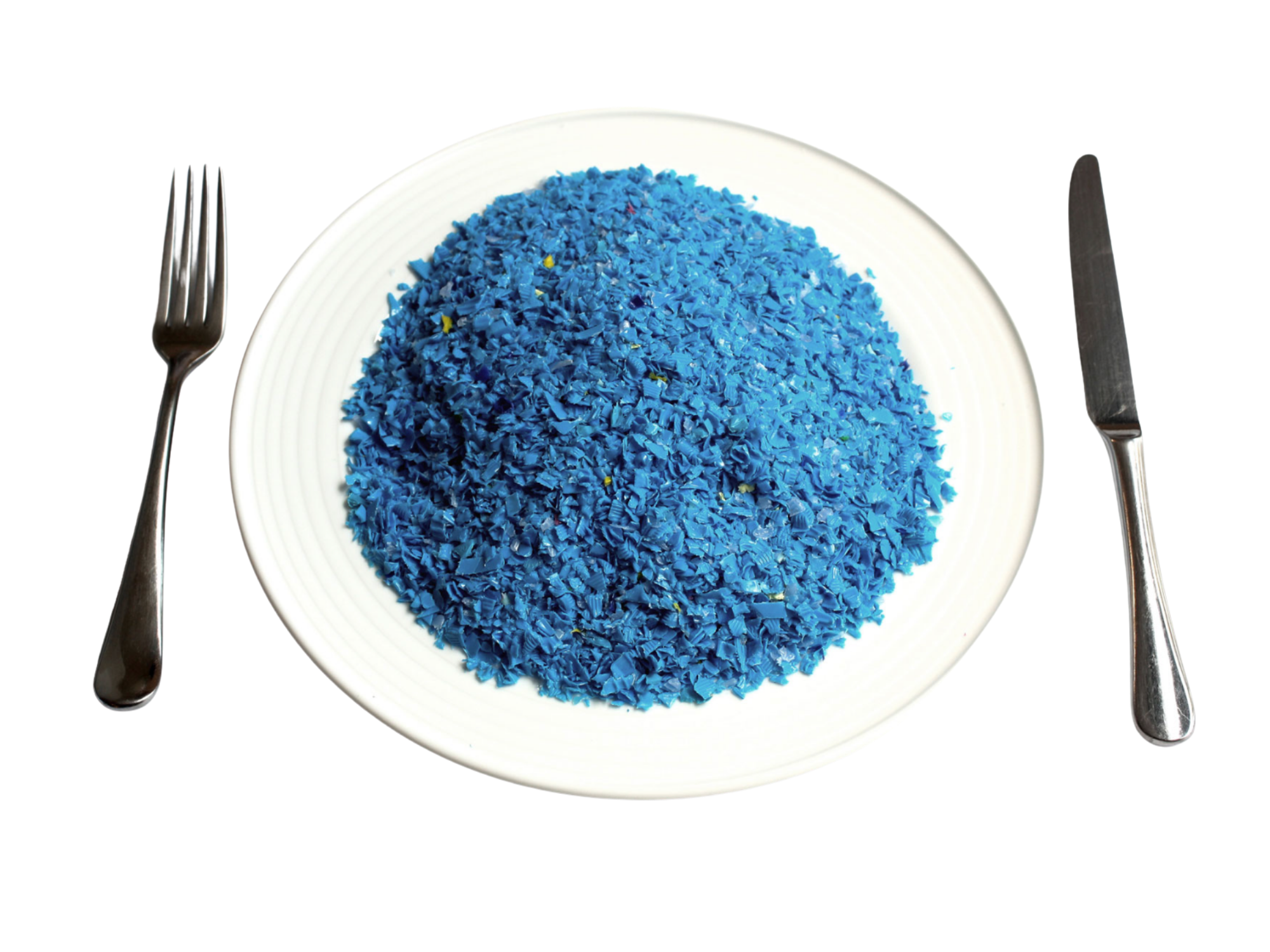 A plate piled with blue plastic fragments, set with a fork and knife, illustrating the amount of microplastics humans consume