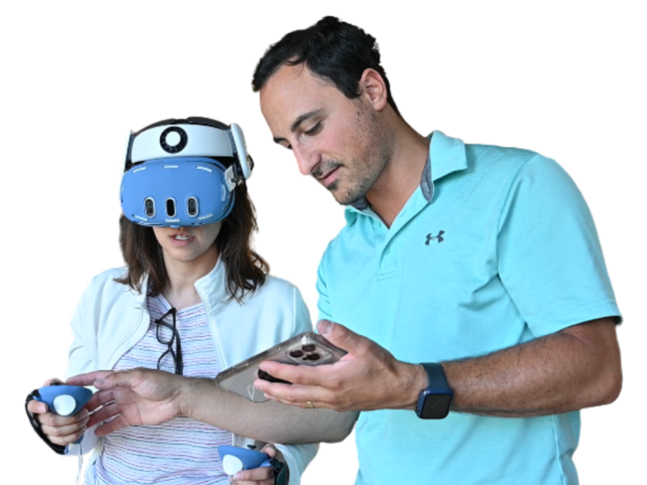 A man and a woman engaging with virtual reality and gaming. The woman is wearing a VR headset and holding game controllers, while the man is looking at a smartphone.