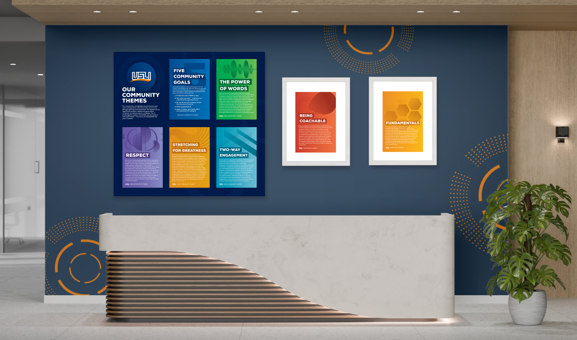 Corporate lobby mockup featuring framed community theme posters displayed on a navy accent wall beside plants and modern furniture.