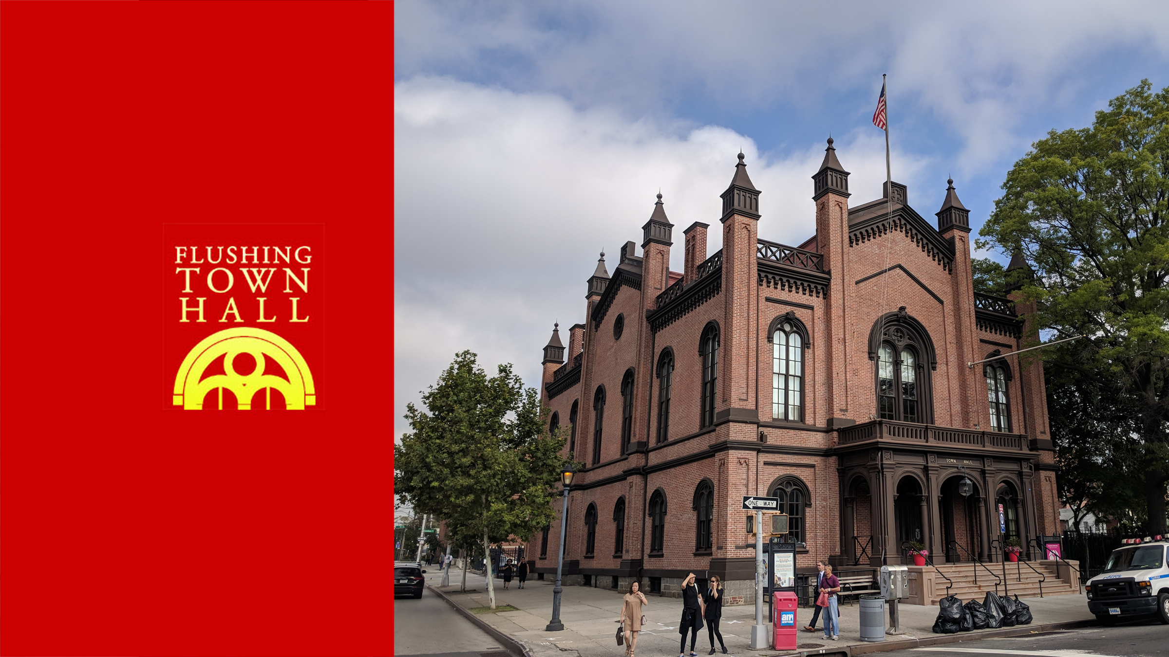 A historic red brick building with gothic architectural features, including arched windows and towers, labeled as Flushing Town Hall.