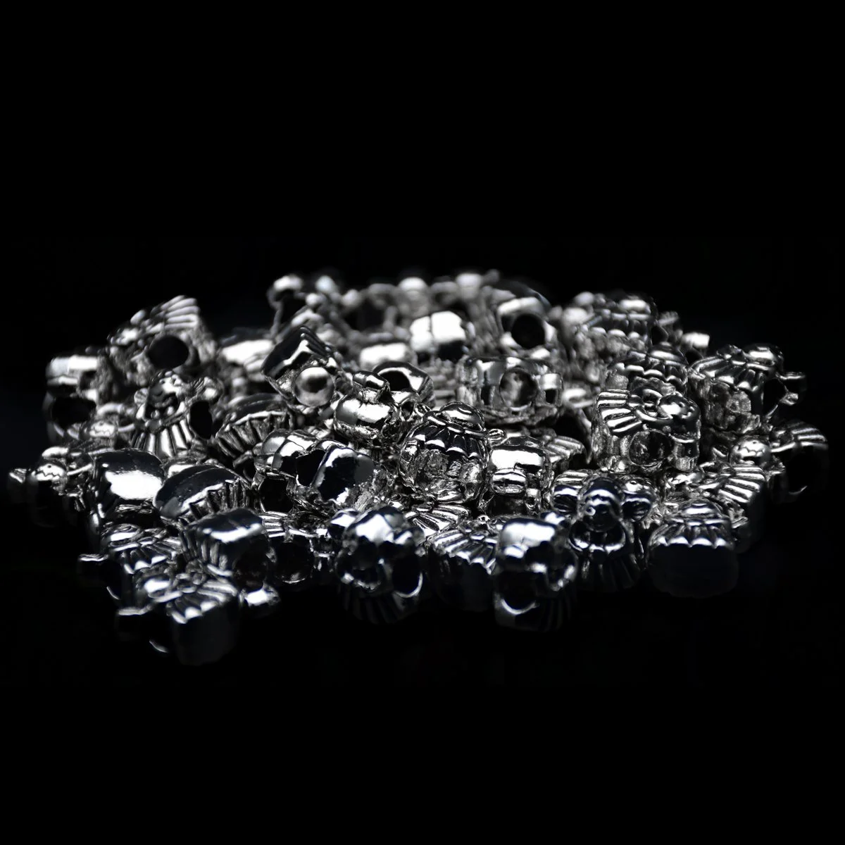 lots of antique Tibetan silver big hole pandora beads with a baby angel shape scattering around in a black background