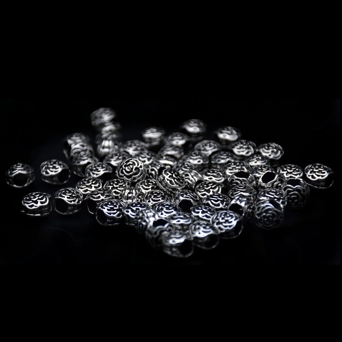 bulk of two rose shape carved big hole pandora beads showcase in black background