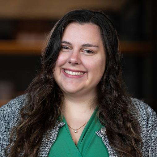 Women with dark brown hair in green button up