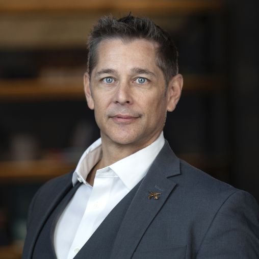 Man in professional attire with dark brown