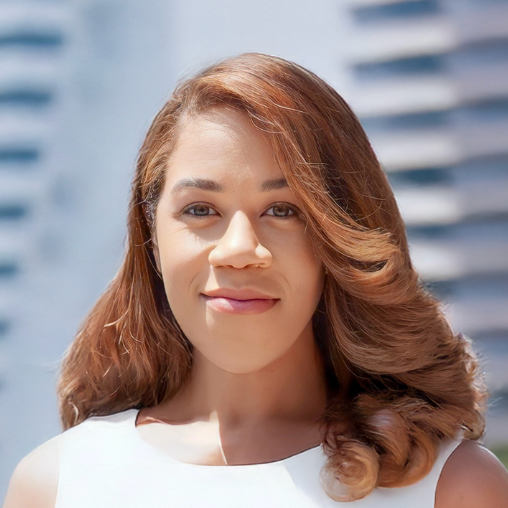 Professional woman with brown hair in a bun, wearing a navy blazer and white shirt, against a dark gray background.