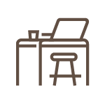Silhouette of a desk with a computer monitor, a cup, and a chair.