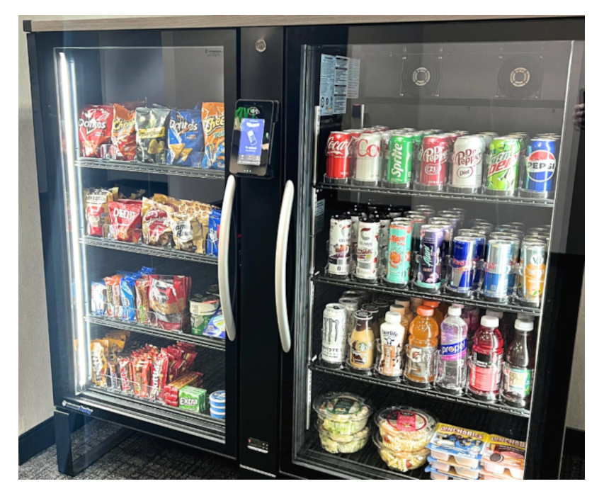 A vending machine with snacks on the left side and beverages on the right side, including soda, energy drinks, and bottled water.
