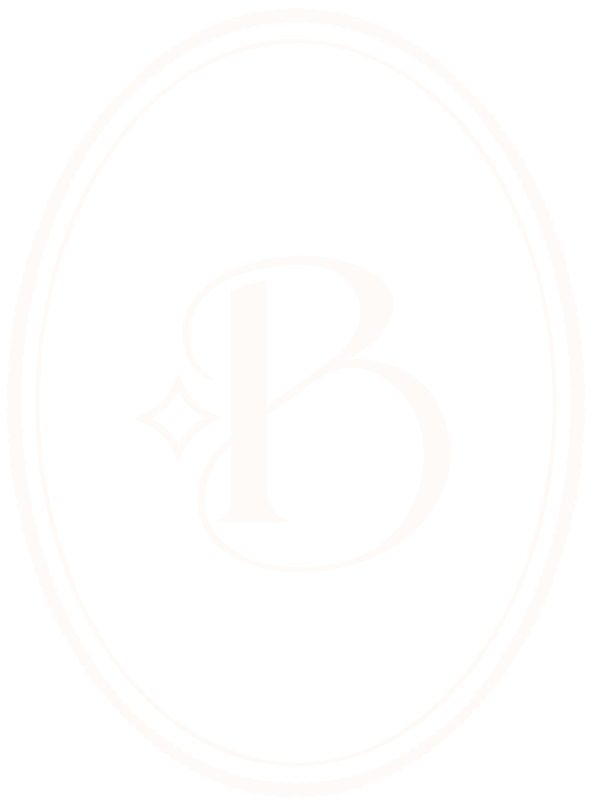 A black oval logo with white decorative border and the letter 'B' in the center, accompanied by a small star-shaped sparkle.