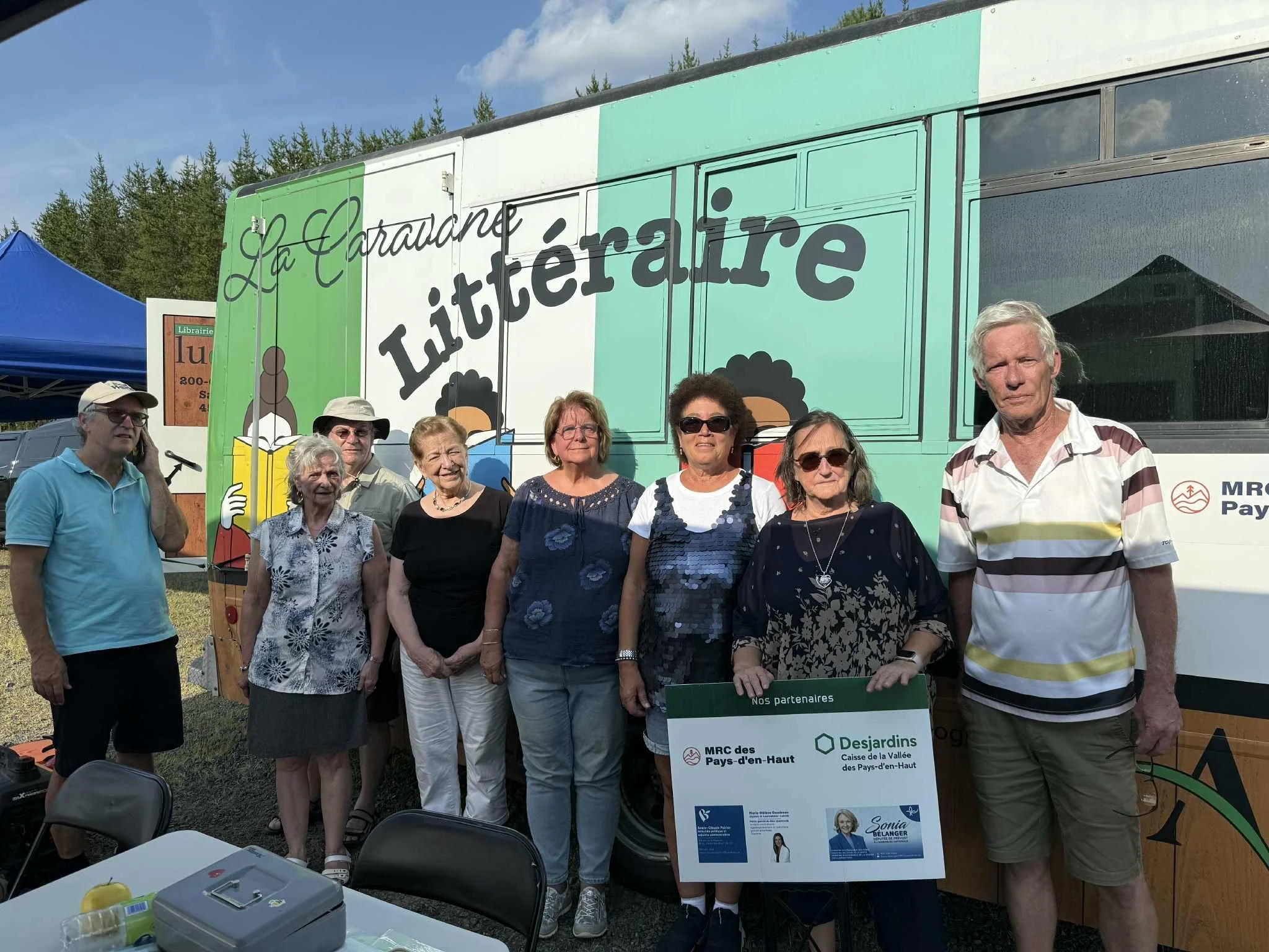 Photo de l'équipe devant la Caravane littéraire de lu et relu