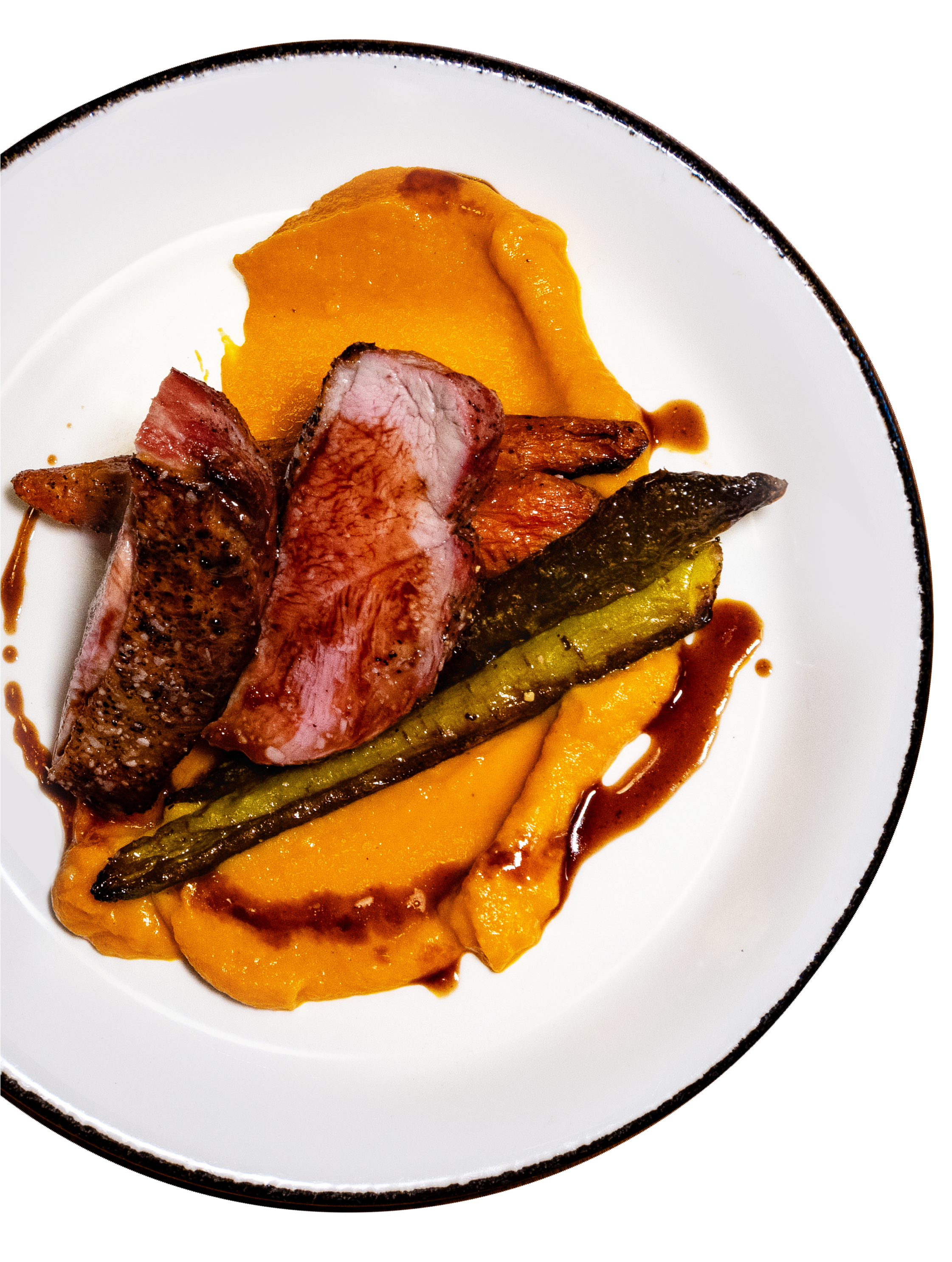 A plated dish featuring a cut of medium-rare steak, roasted green asparagus, and a swirl of mashed sweet potatoes with a drizzle of brown sauce.