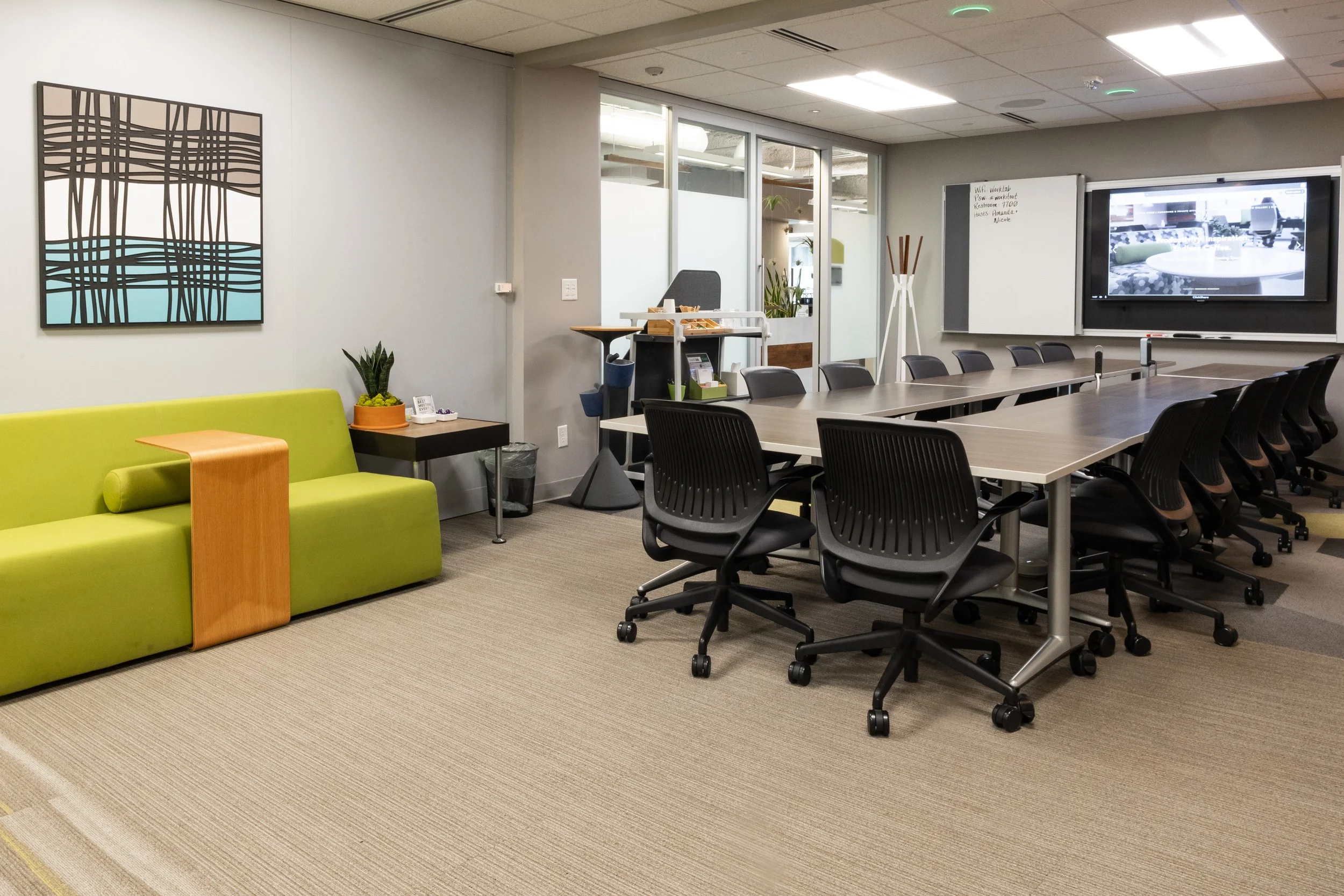 Person sitting at a desk holding a pen and a notebook, with a black coffee mug labeled 'worklab' nearby.