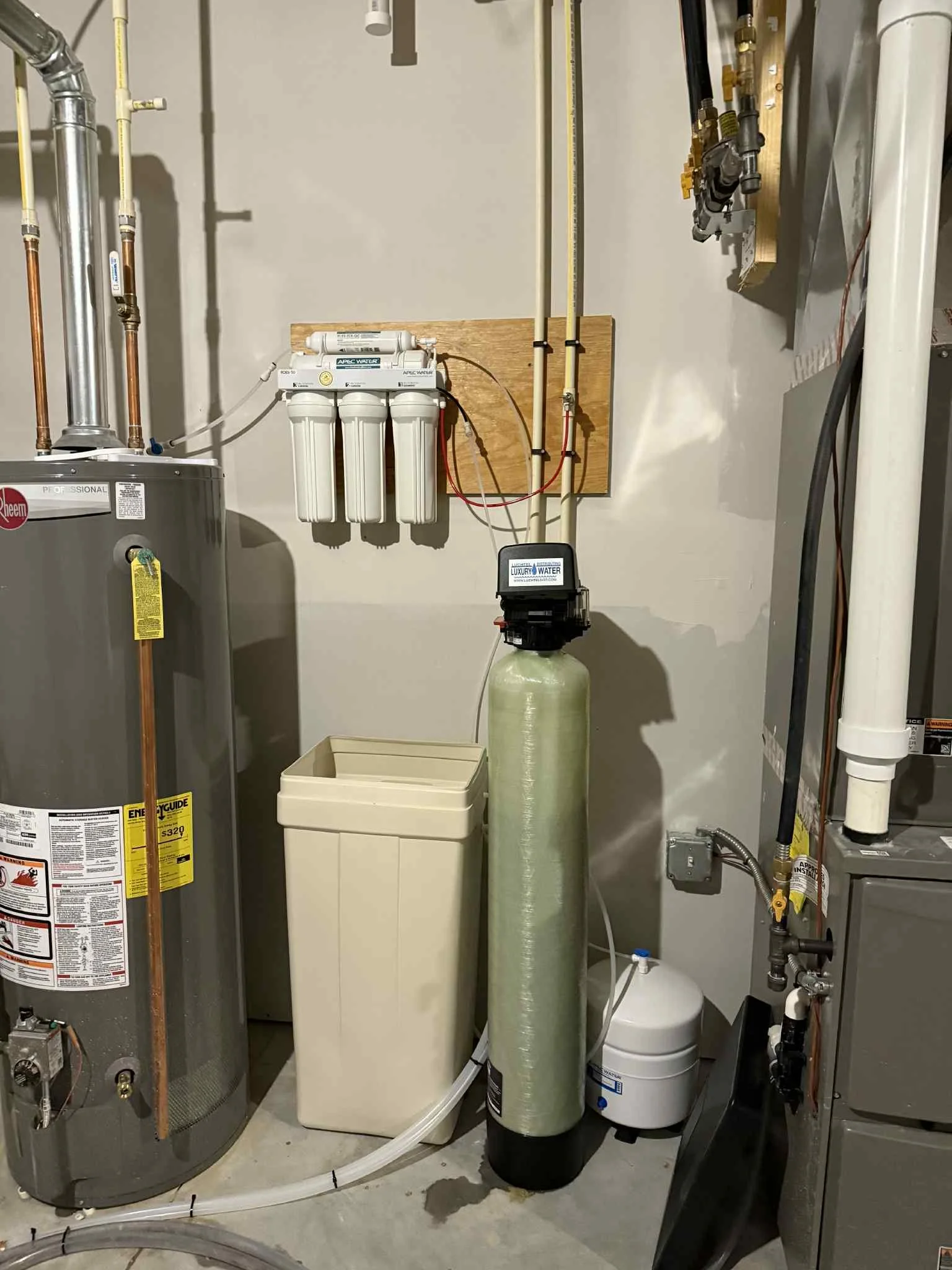 Water filtration system and water heater in utility room.