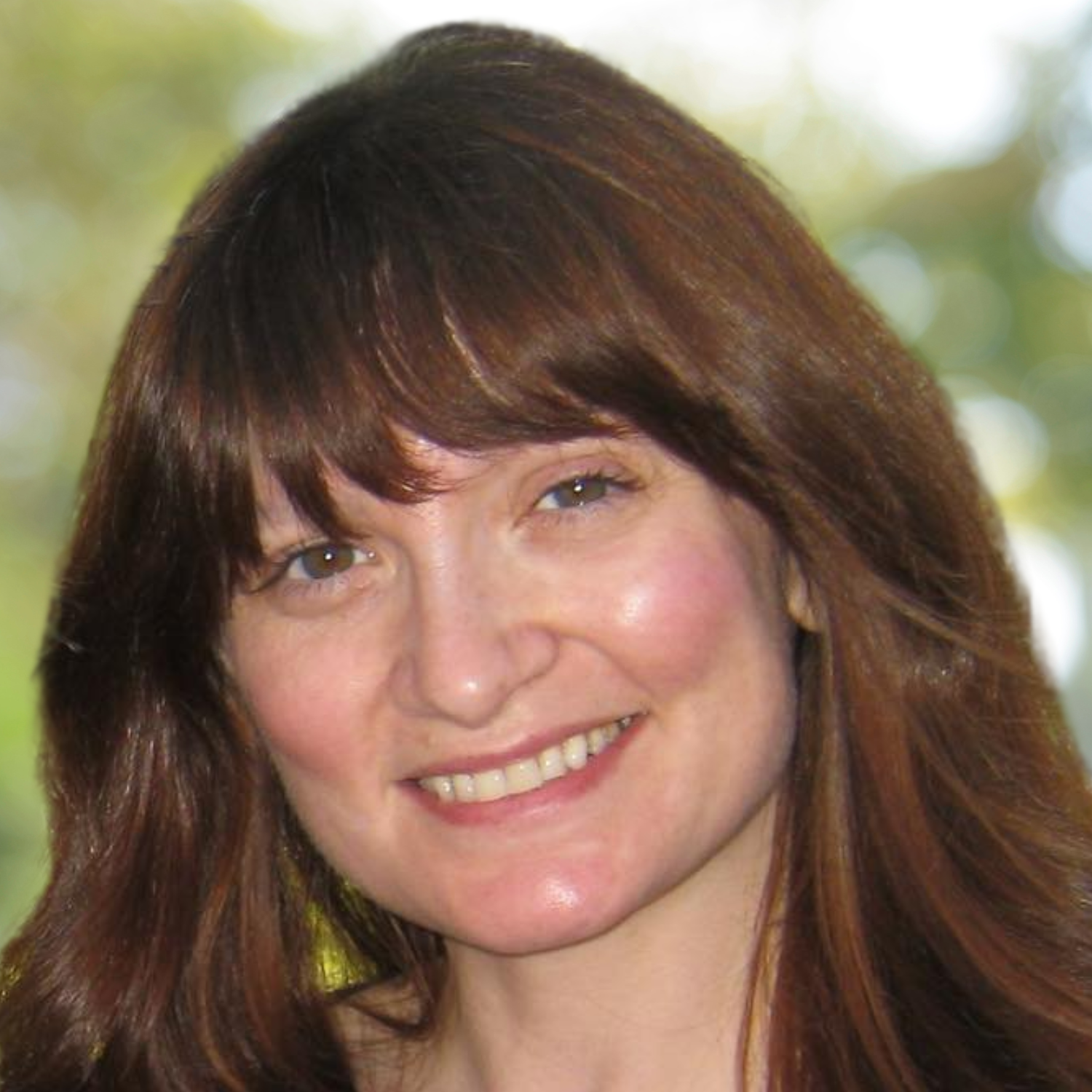 Close-up of a woman with long, wavy brown hair, smiling softly, against a blurred, green, abstract background.