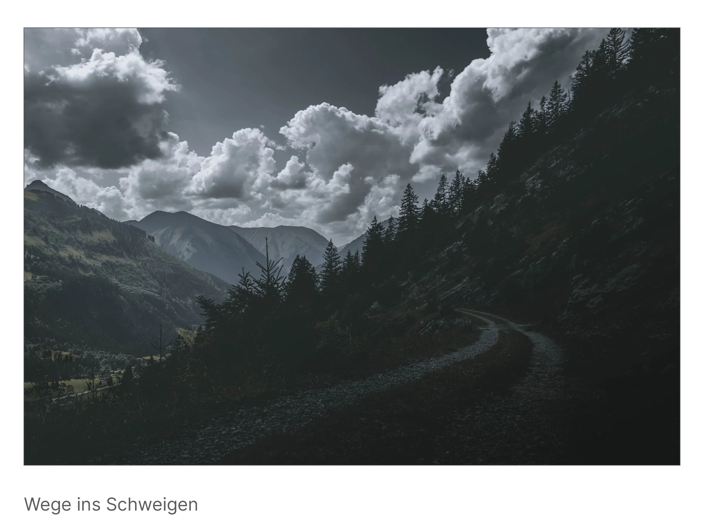 Krummer Pfad führt in ein Tal zwischen Bergen, Wolken türmen sich am Himmel – Einladung zum Rückzug und Innehalten.