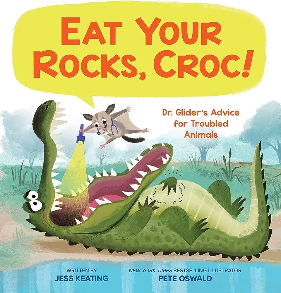 Book cover titled 'Eat Your Rocks, Croc!'. Illustration of a crocodile with an open mouth showing teeth and a tongue, with a small animal, possibly a dog or raccoon, wearing a stethoscope and holding a flashlight, flying above the crocodile in a gras