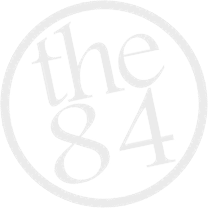 A circular logo with the text 'the 84' inside.