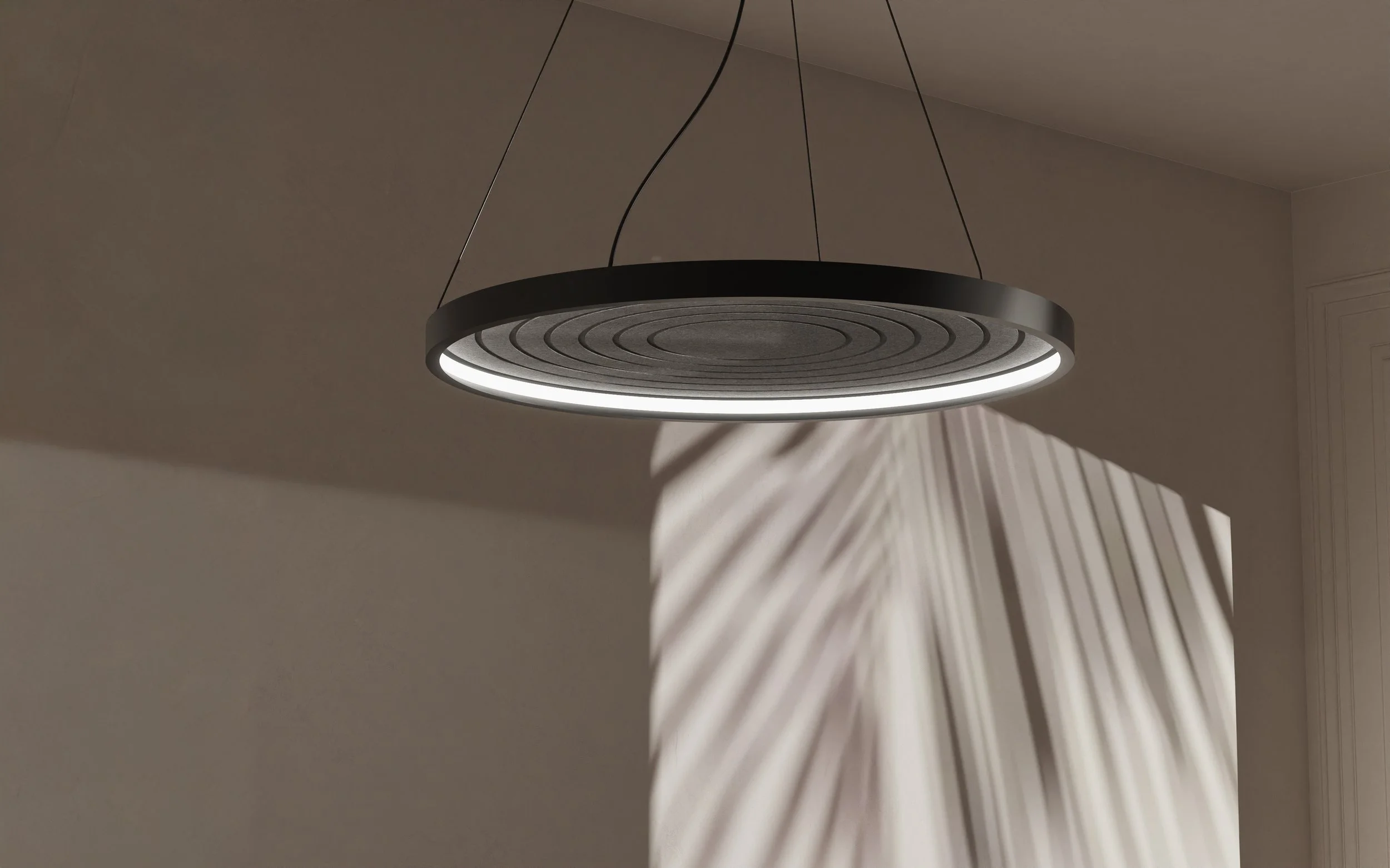 Modern circular ceiling light fixture casting intricate shadow pattern on the wall.