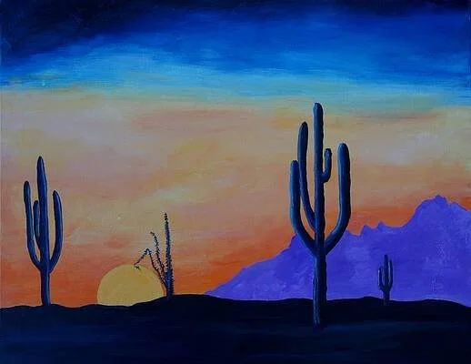 Sunset over a desert landscape with saguaro cacti and purple mountains.