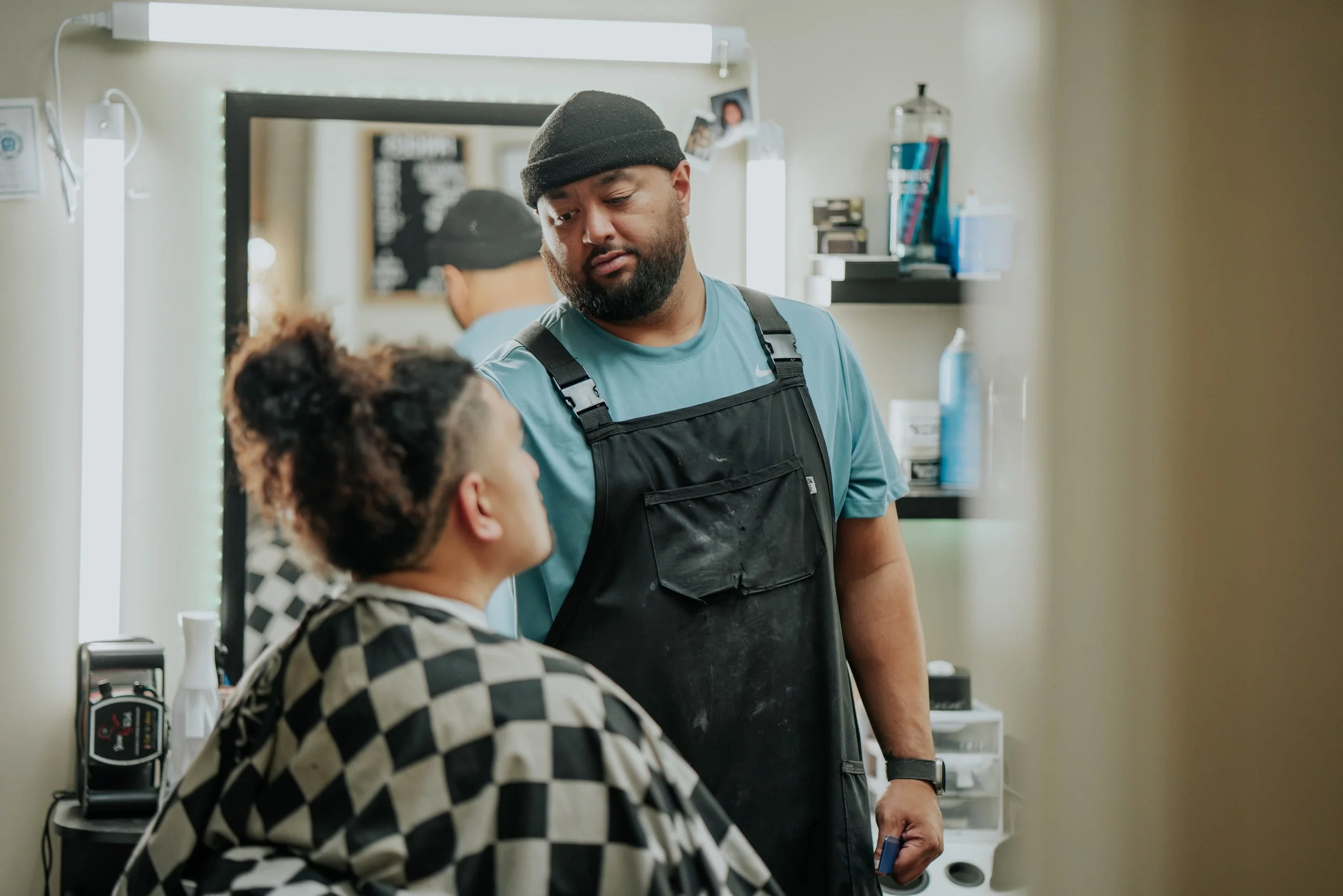 Barber talking to a customer in a barbershop
