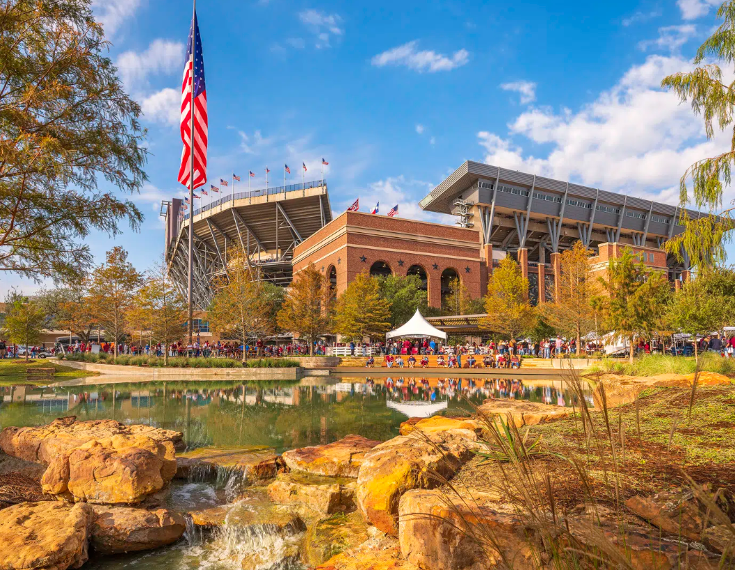 Priest dressed in gold and white vestments conducting a religious ceremony at an ornate altar inside a church, with a young boy assisting.