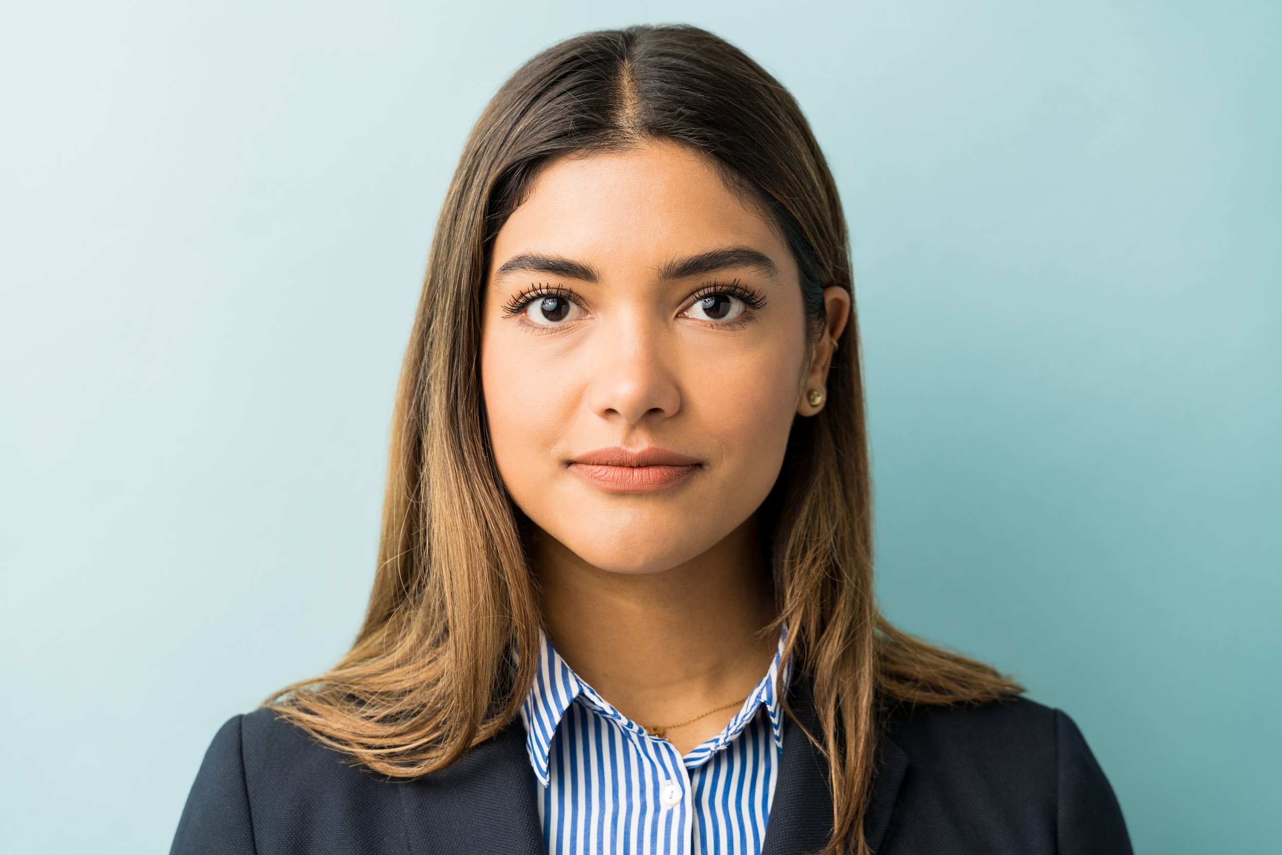 closeup-young-female-professional-making-eye-contact-against-colored-background.jpg