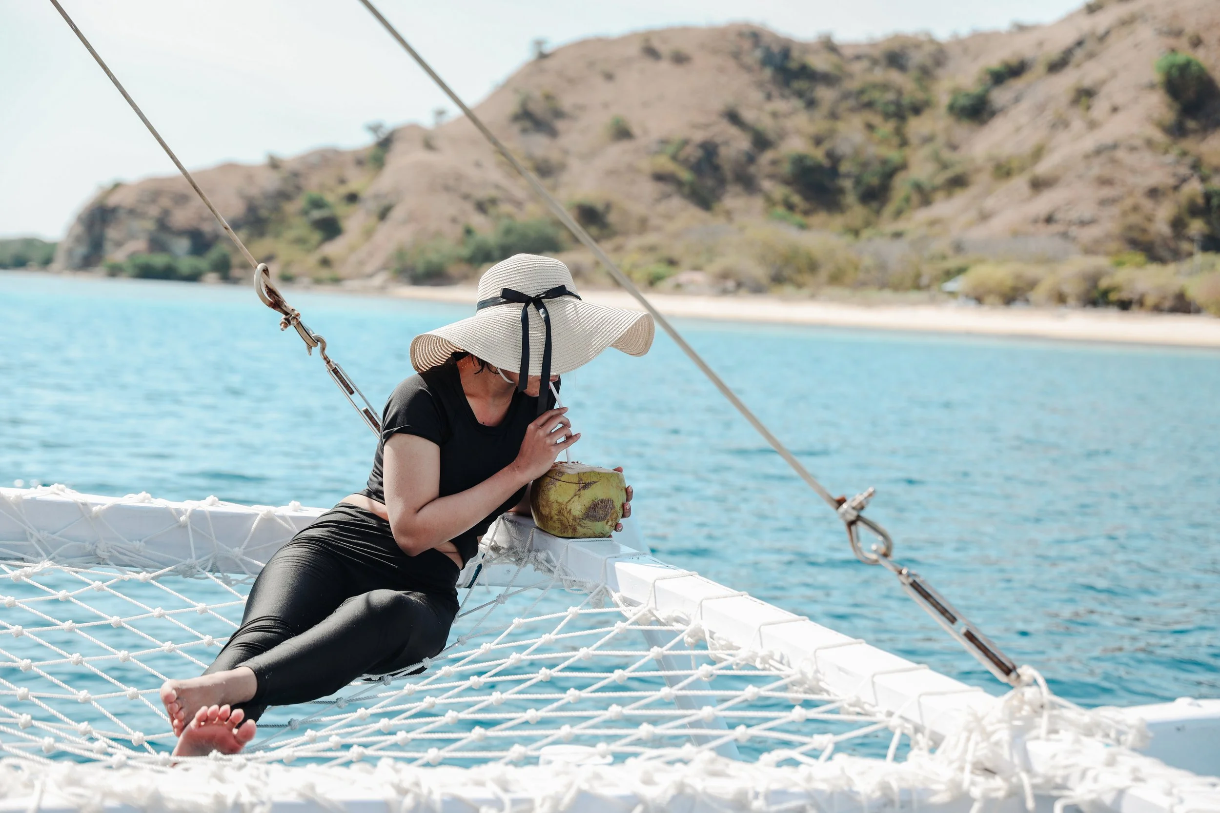 vecteezy_a-girl-enjoying-coconut-during-summer-holiday-on-the-sea_7104200.jpg