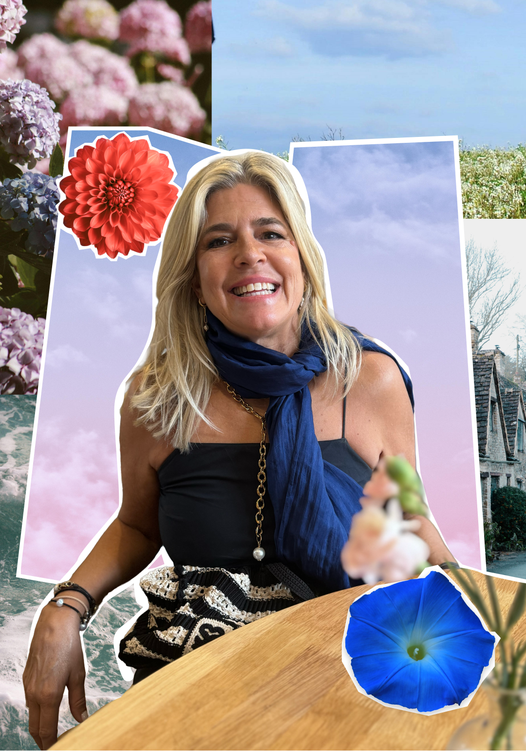 A smiling blonde woman wearing a black top and blue scarf, sitting at a table with colorful collaged backgrounds of flowers, sky, and a house.