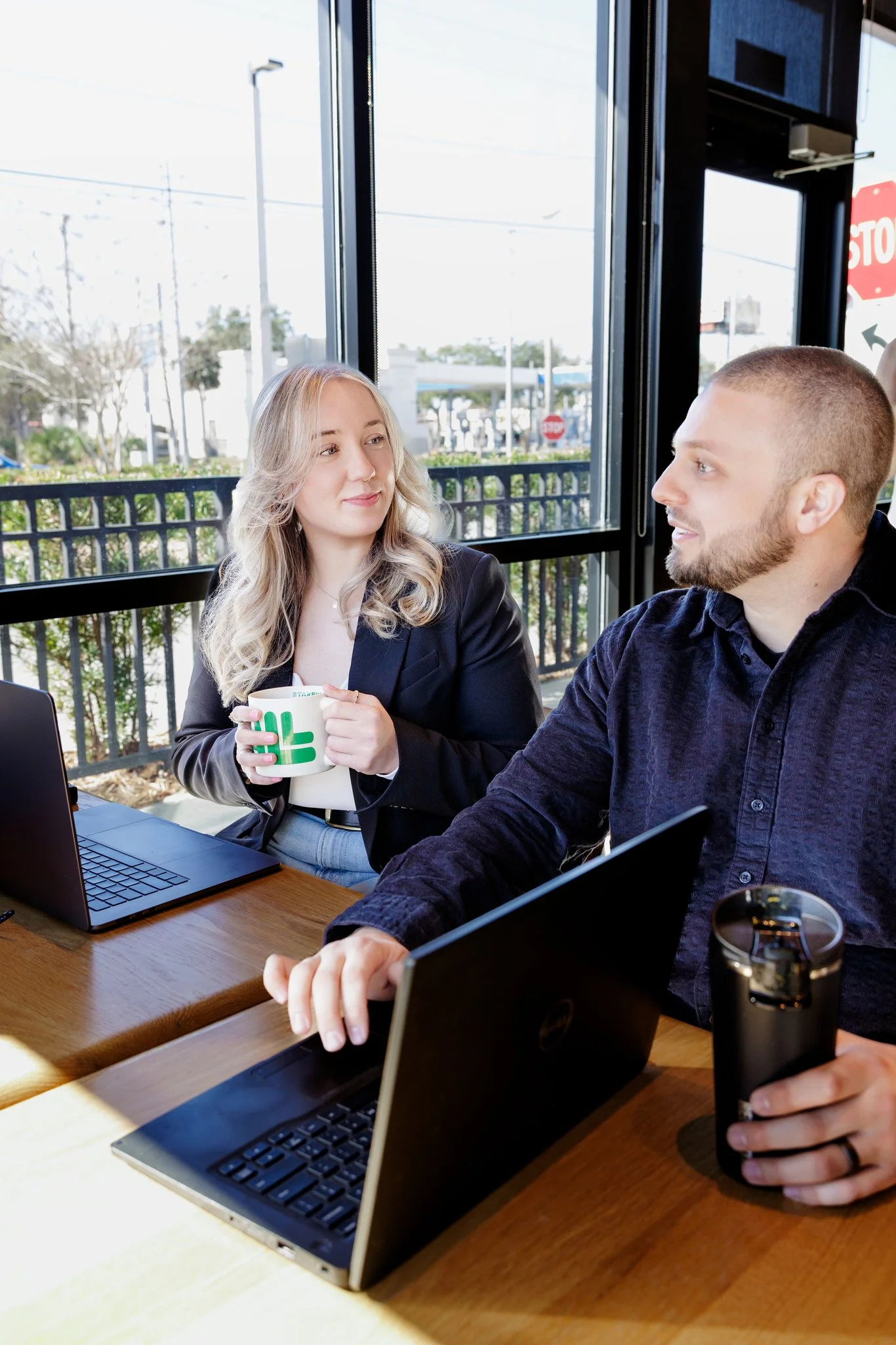 Jon and Nikki from Dick Bailey Service discussing appellate work at coffee shop