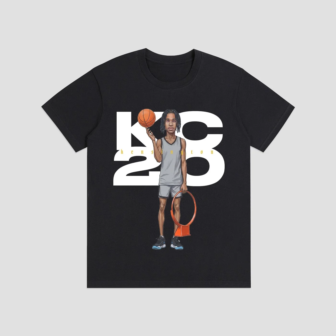 Black T-shirt featuring an illustration of a basketball player with dreadlocks holding a basketball in one hand and a towel in the other, with large white text reading "KOS 23" and small yellow text "KENSINGTON" on a light gray background.