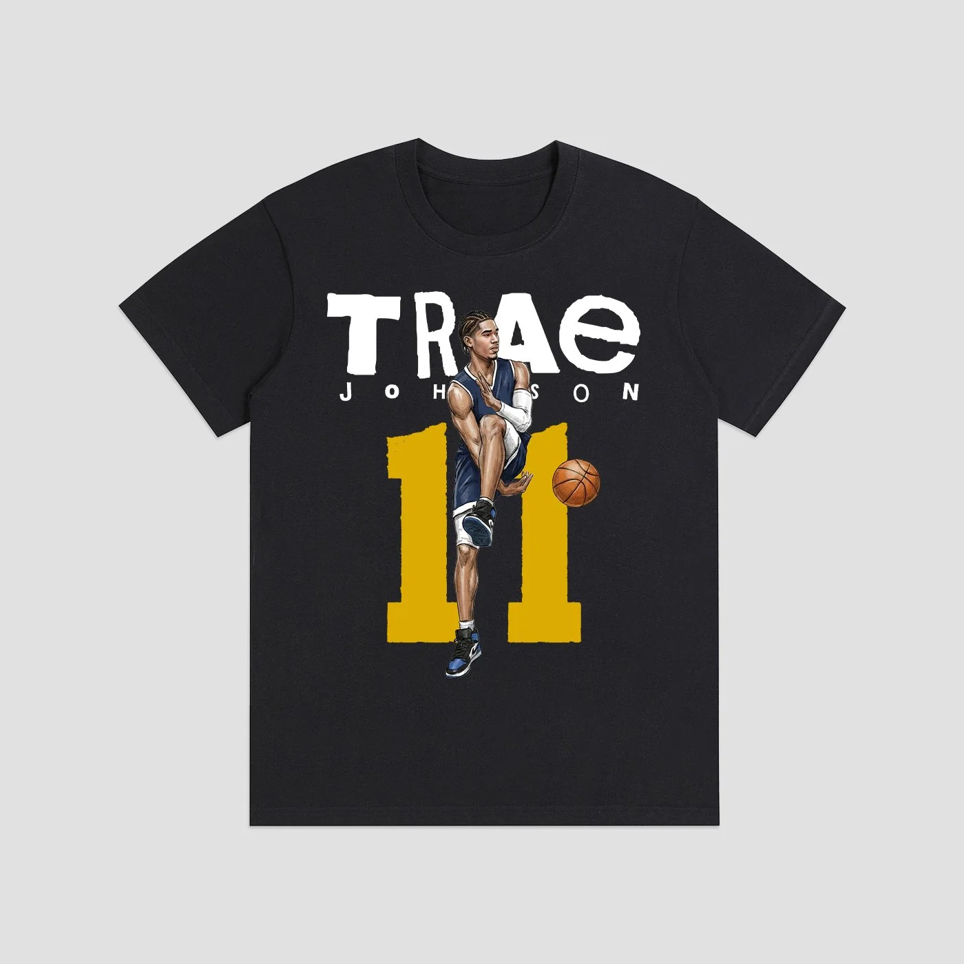 Black T-shirt featuring a graphic of a basketball player in action, with the text 'TRAE' and 'JOHNSON' above and below the graphic, and a large yellow number "11" in the background.