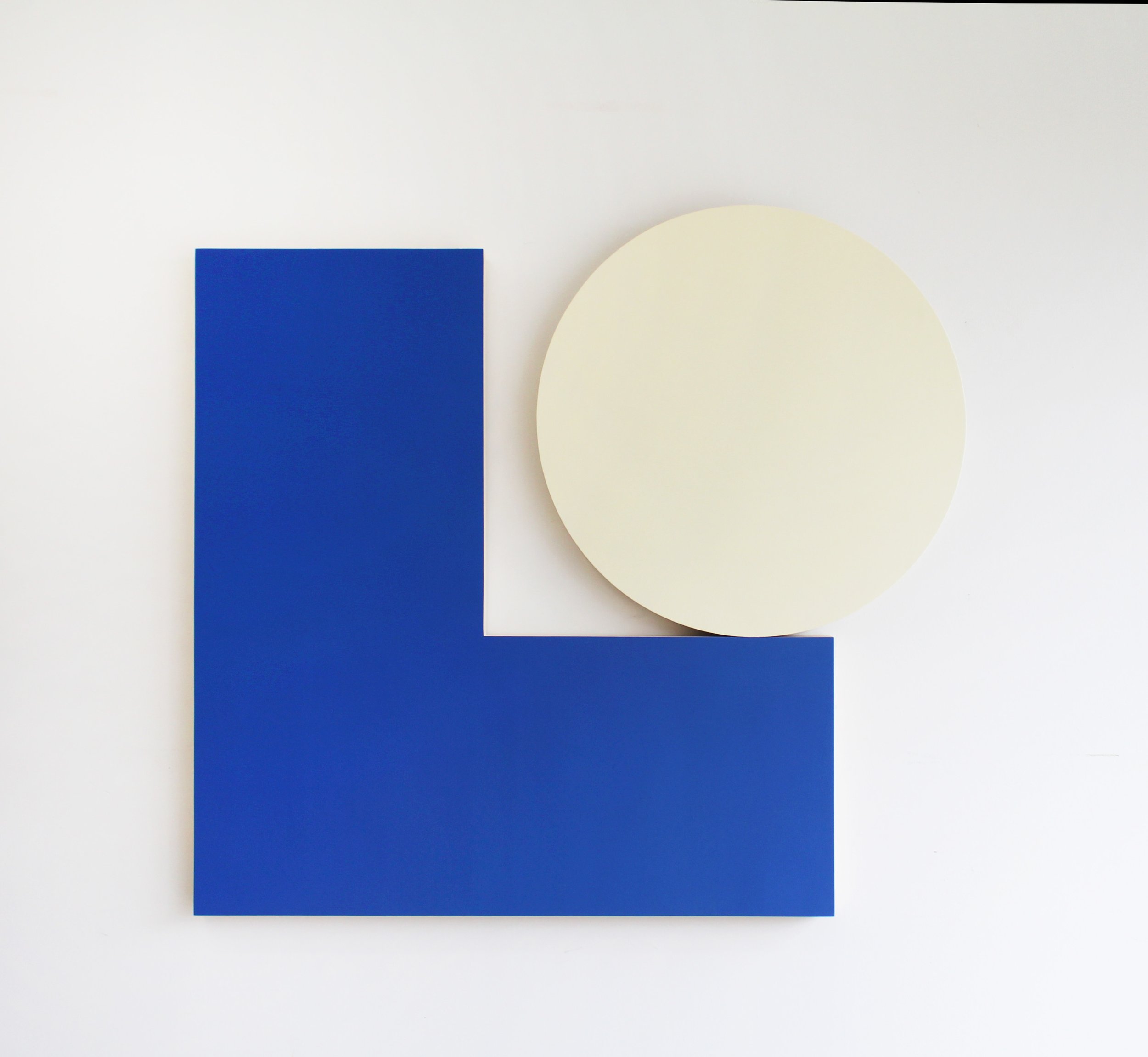 Abstract minimalist artwork with a large white background, featuring a blue rectangular shape and a curved off-white circle overlapping each other.