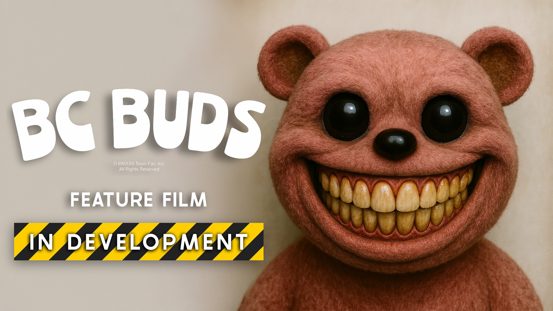 A plush toy resembling a smiling bear with a distorted face, large black eyes, black nose, and big yellow teeth. The background is plain and beige.