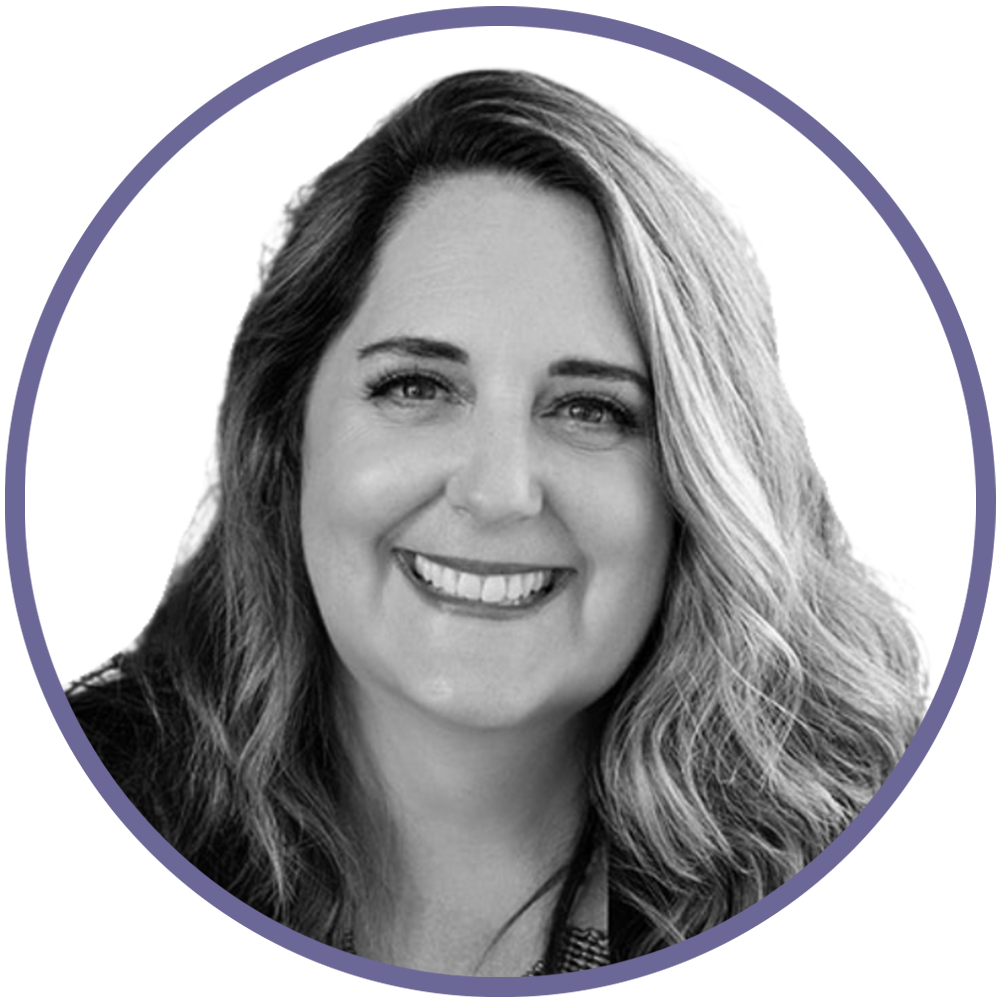 Black and white photograph of a woman with long, wavy hair smiling.