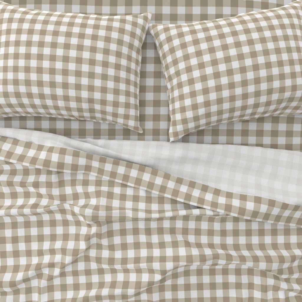 Close-up of a bed with beige and white checkered pillowcases and bedding.