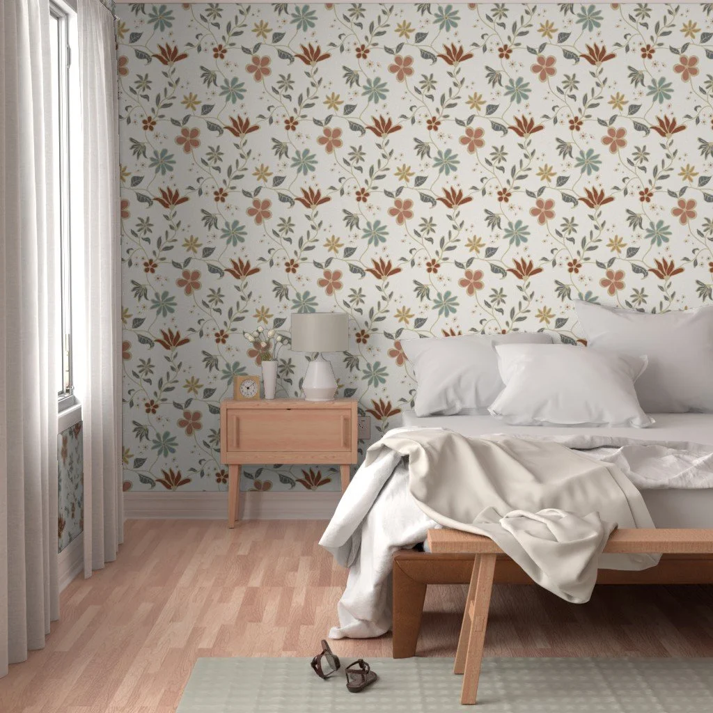 A bedroom with floral wallpaper, a bed with white bedding and pillows, a wooden nightstand with a lamp, clock, and vase, beige curtains, and a pair of glasses on the floor.