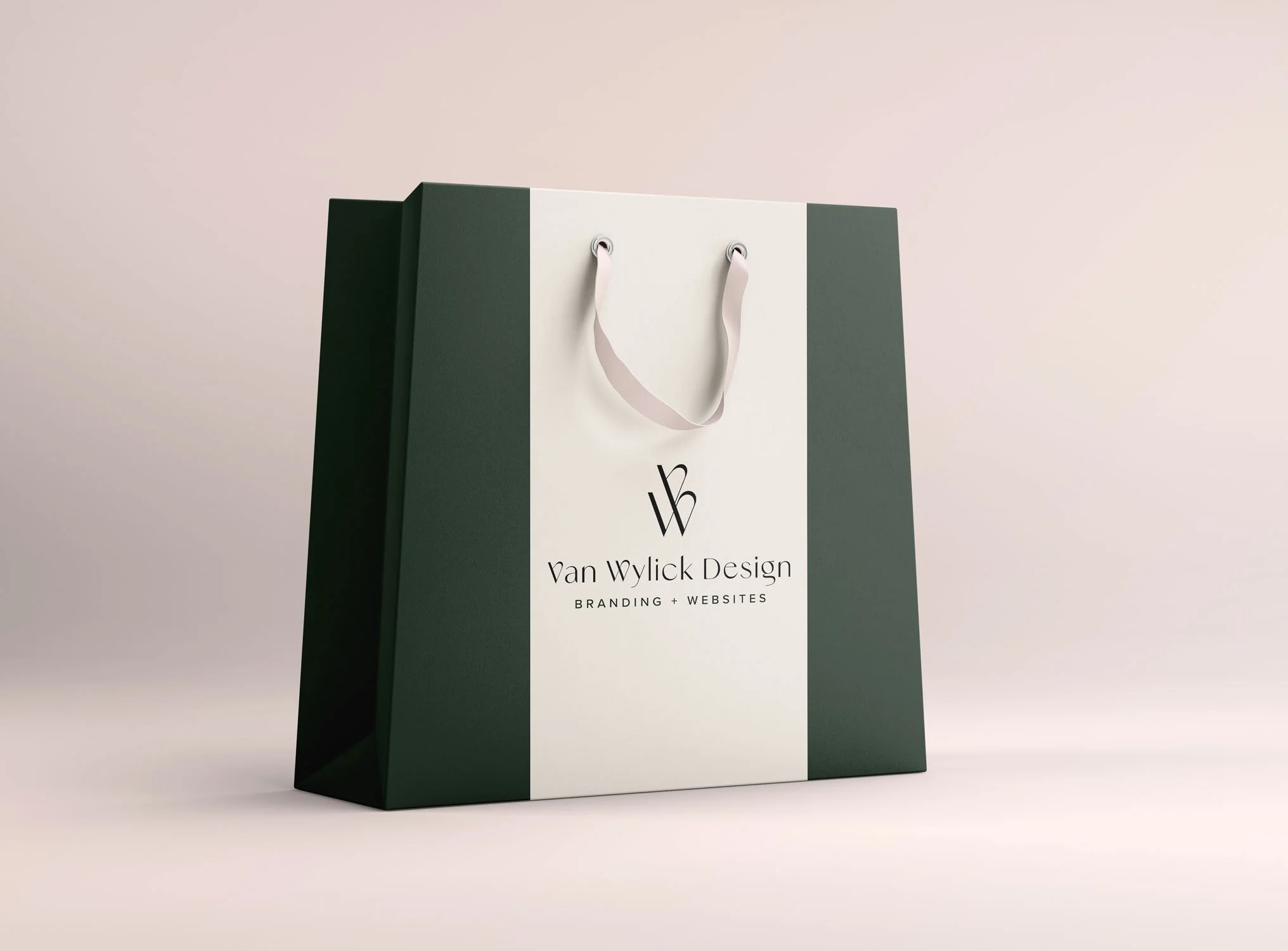 Green and white paper shopping bag with logo and text for Van Wylick Design, featuring branding and web services.