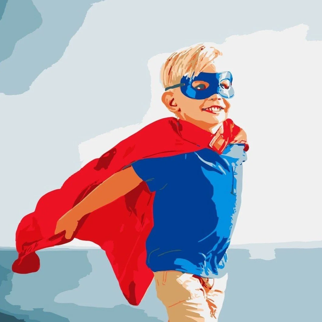 Child dressed as a superhero wearing a blue mask, red cape, blue shirt, and beige pants, smiling and looking upward, with arms outstretched in a confident pose.