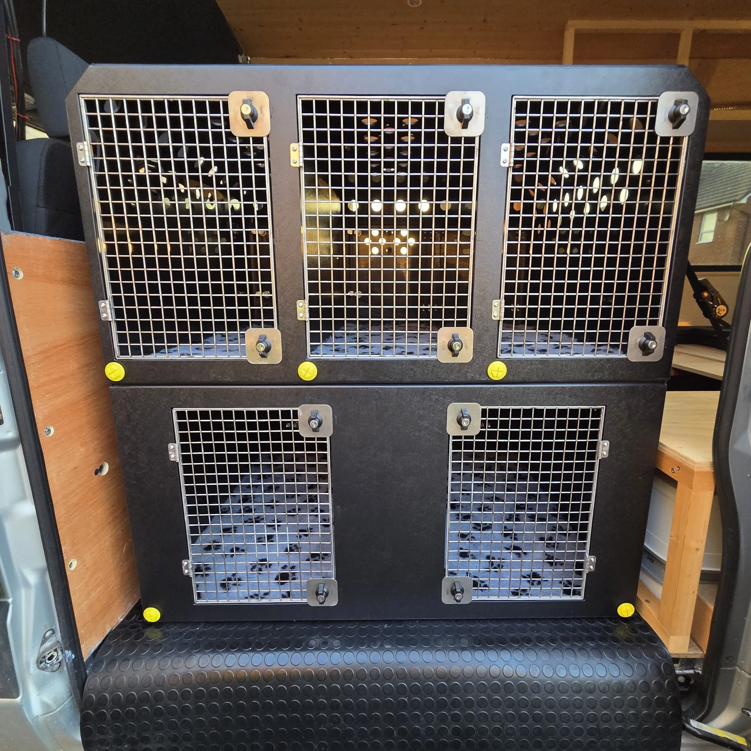 dog crates inside a van