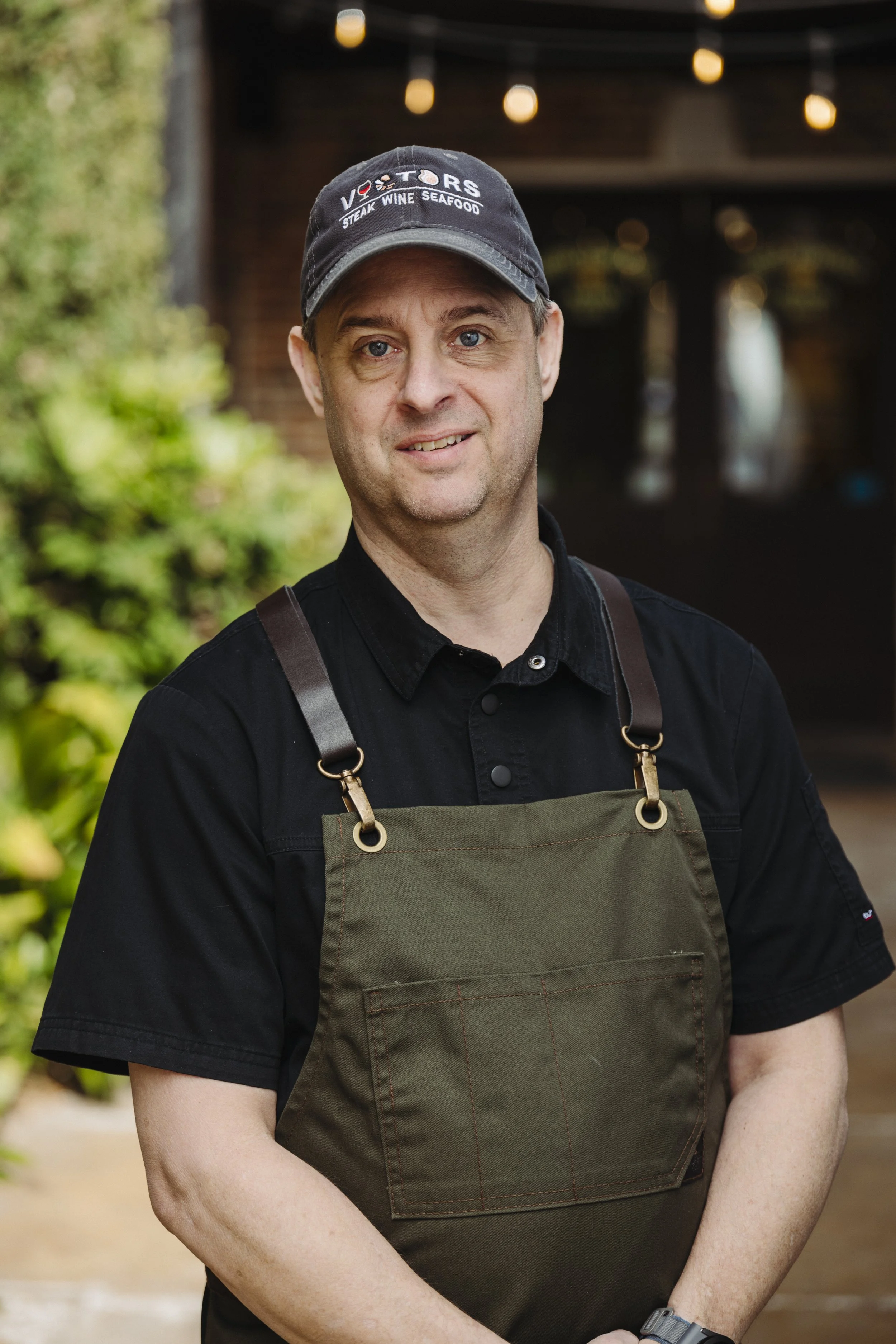 Chef Cooper in a green apron