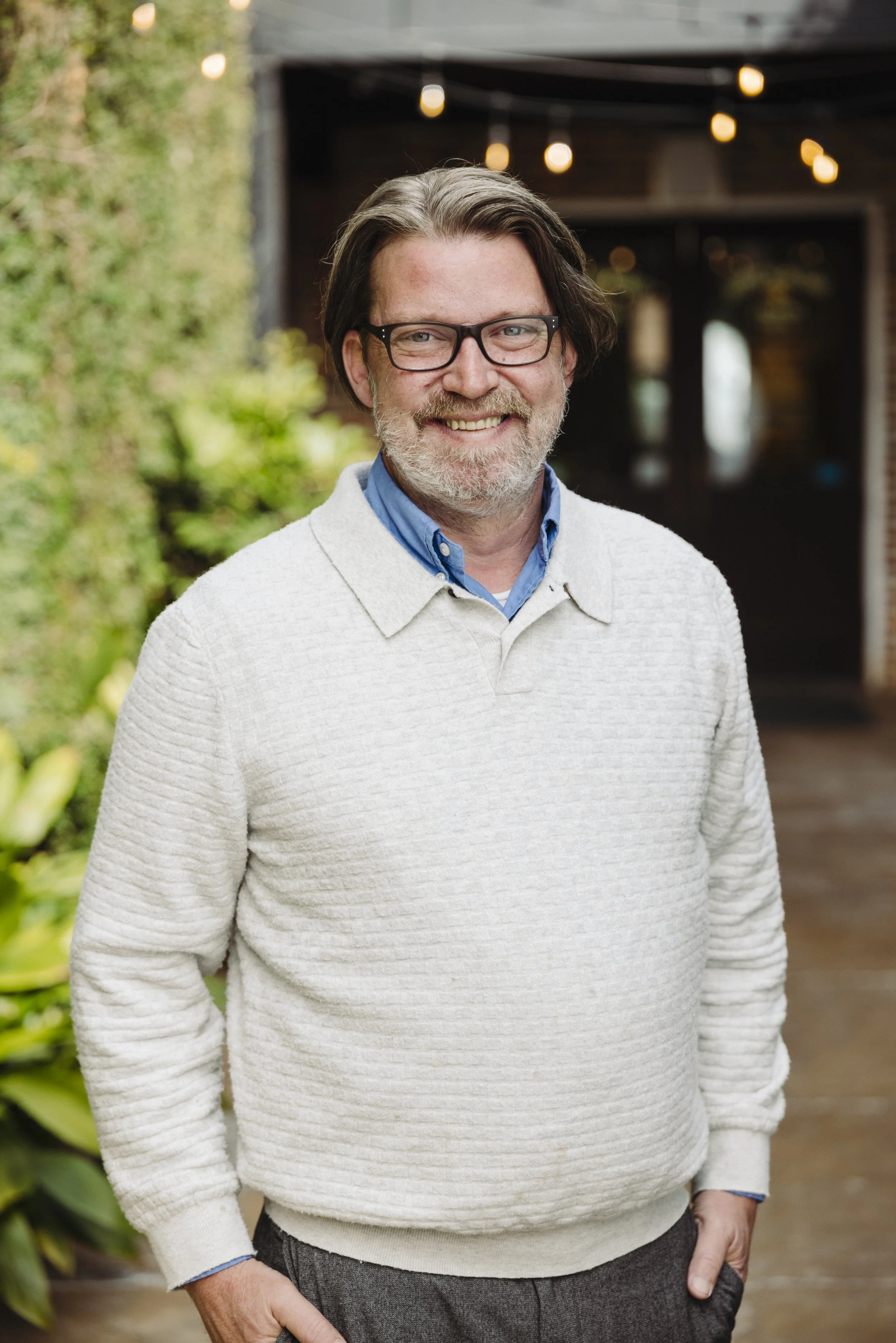 Johnathan in a cream colored sweater