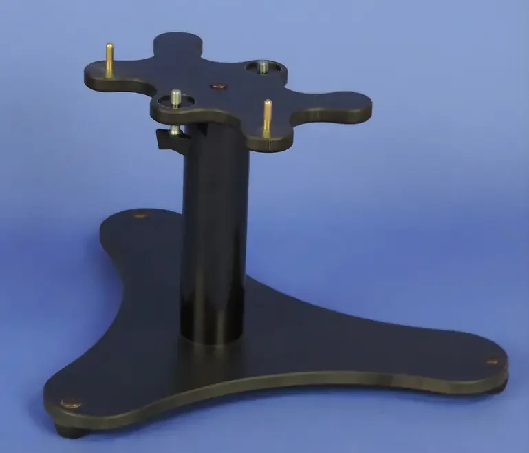 A black tripod stand with a circular mount at the top and a curved base, used for mounting a device or equipment.
